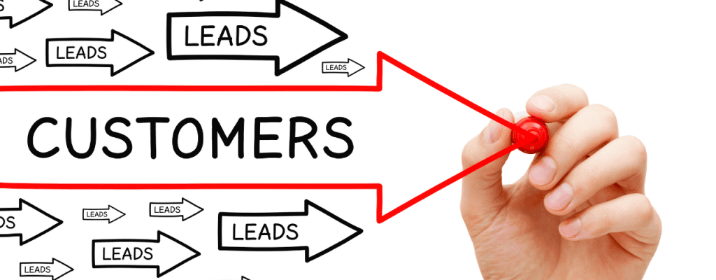 Hand drawing a red arrow labeled "CUSTOMERS" with multiple smaller arrows labeled "LEADS" pointing toward it, symbolizing leads that convert into paying customers.
