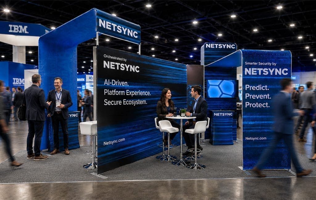Visitors at the blue Netsync trade show booth